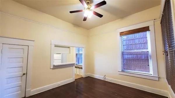 a view of a livingroom with a ceiling fan and window