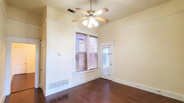 wooden floor in an empty room with a window