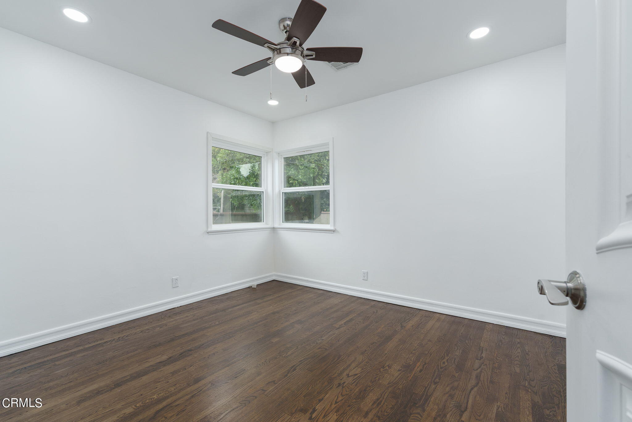 20205 Schoolcraft Street Winnetka, CA 91306 - Photo 14 of 22 wooden floor in an empty room with a window