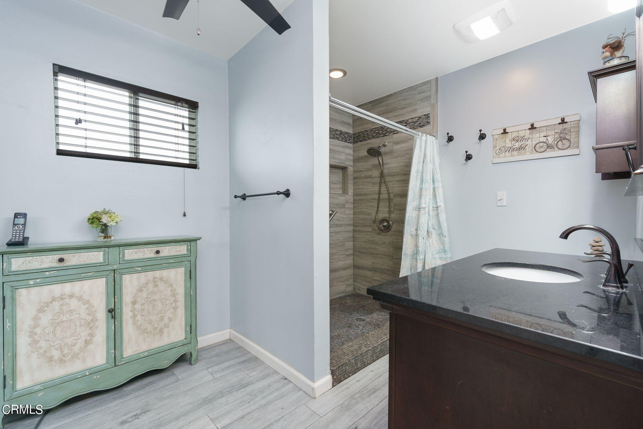 20205 Schoolcraft Street Winnetka, CA 91306 - Photo 19 of 22 a bathroom with a granite countertop sink a mirror and shower