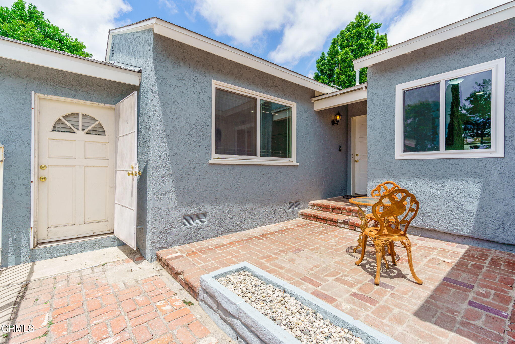 20205 Schoolcraft Street Winnetka, CA 91306 - Photo 2 of 22 a backyard of a house with table and chairs