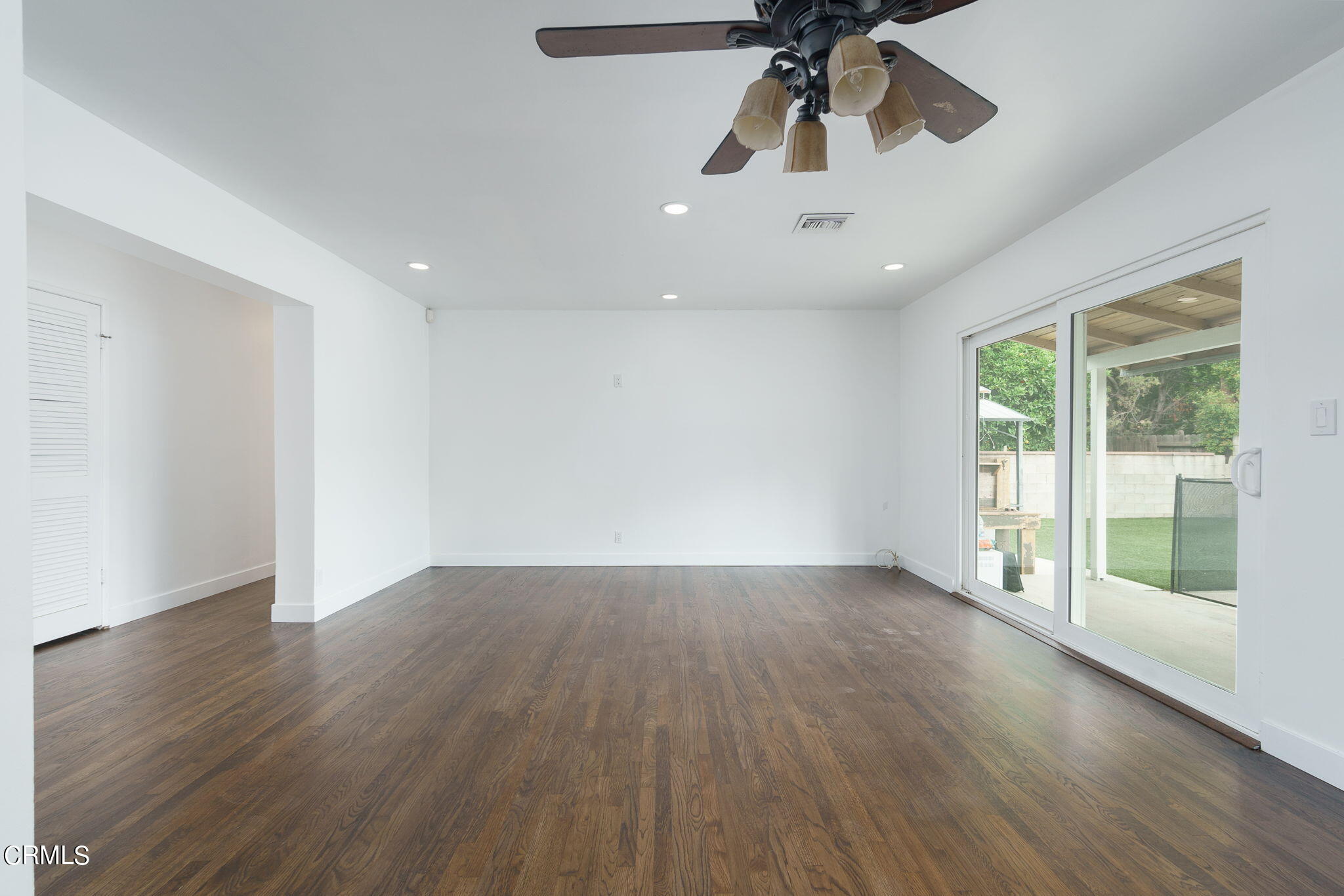 20205 Schoolcraft Street Winnetka, CA 91306 - Photo 5 of 22 a view of an empty room with wooden floor and a window