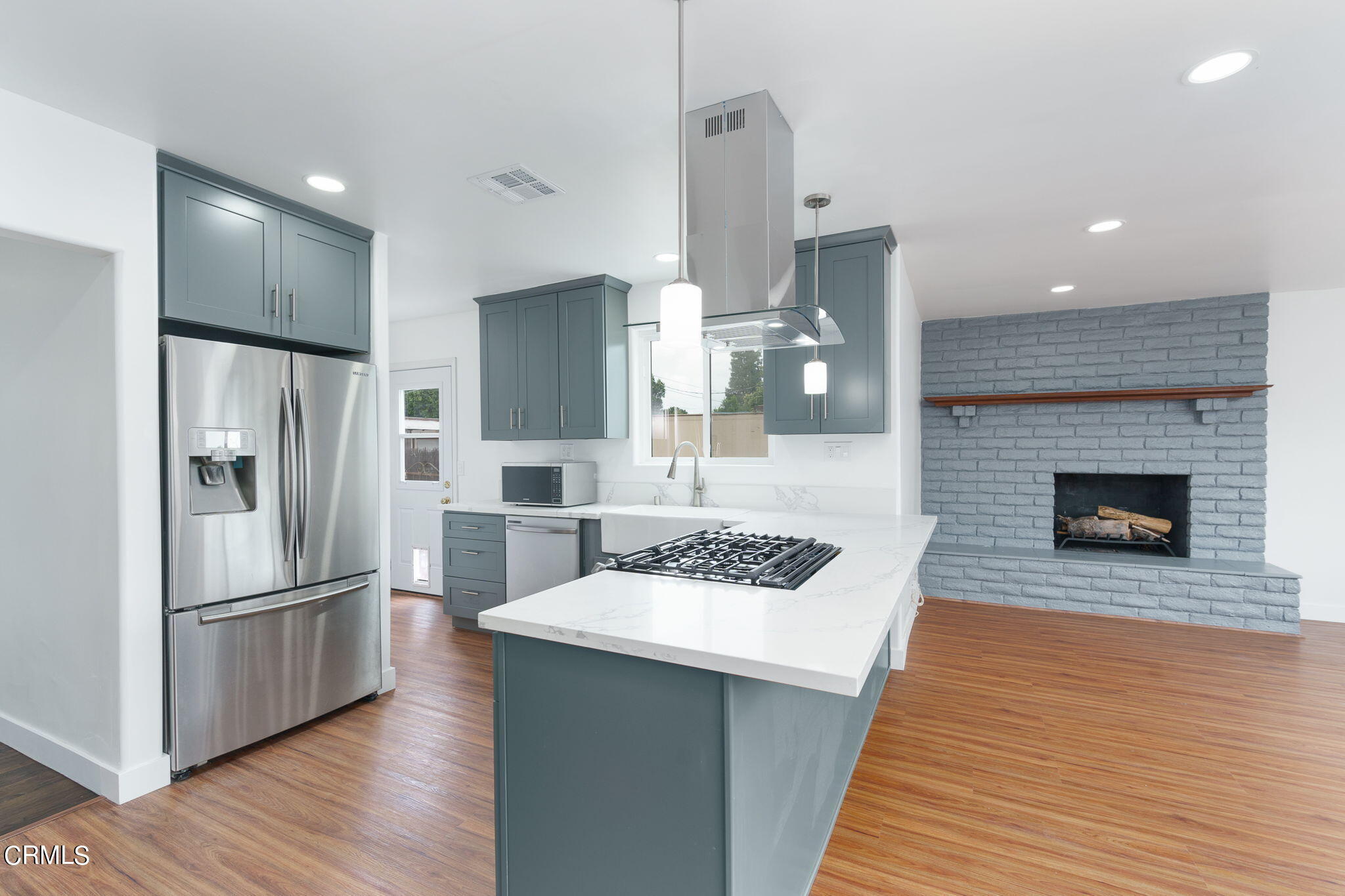 20205 Schoolcraft Street Winnetka, CA 91306 - Photo 8 of 22 a kitchen with stainless steel appliances granite countertop a refrigerator a stove and a wooden floors