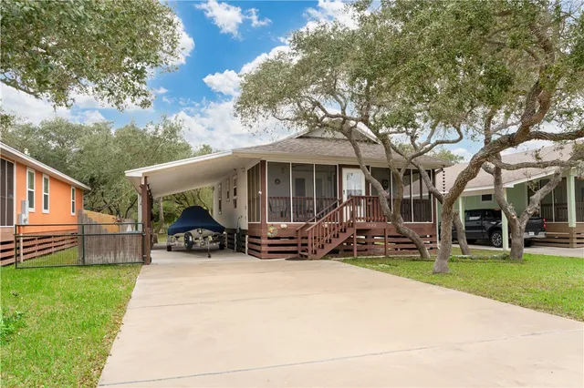 a view of a house with backyard porch and sitting area