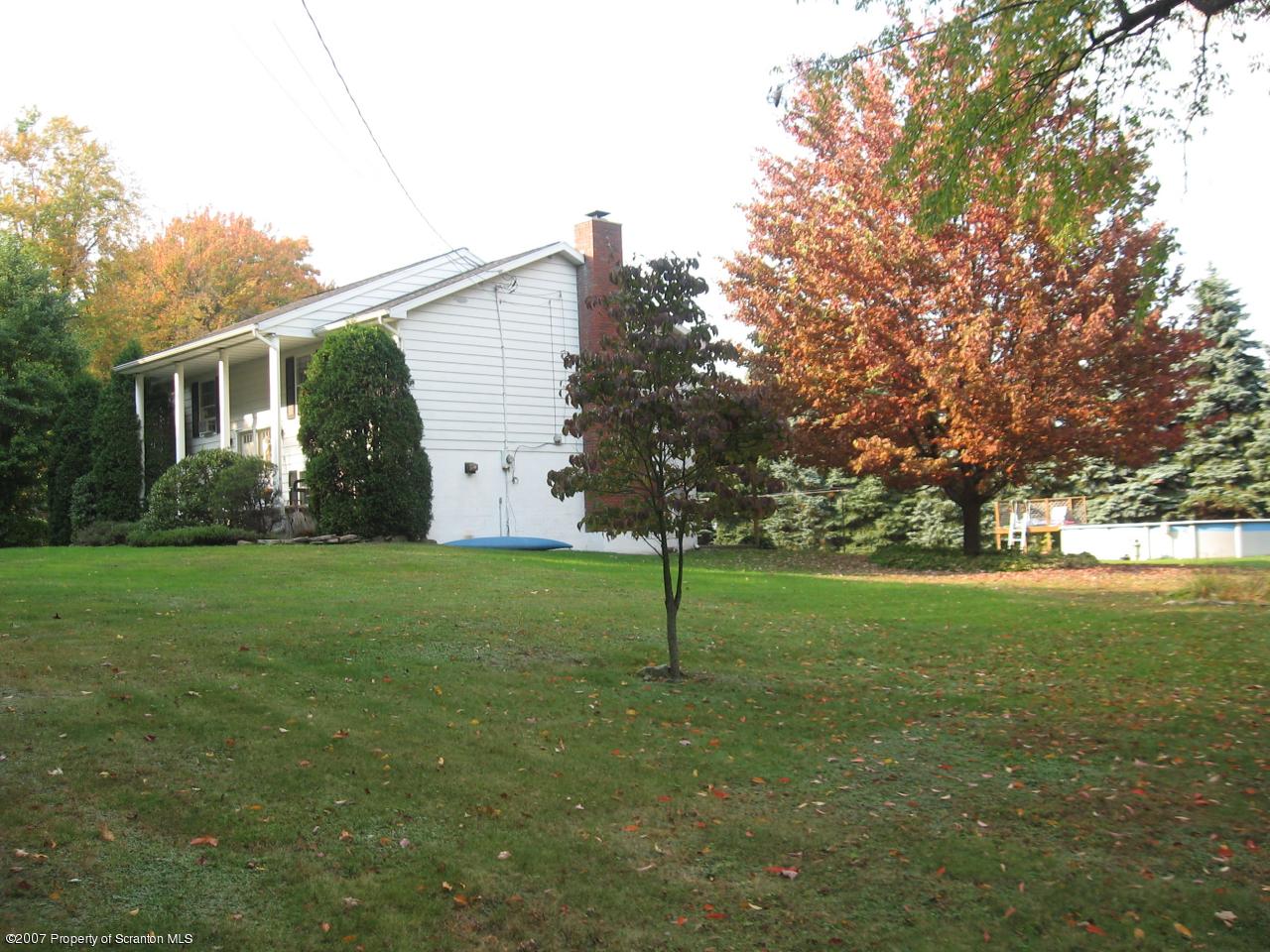 343 Fox And Hound Road Moscow, PA 18444 - Photo 2 of 4 a view of a backyard with potted plants and large trees