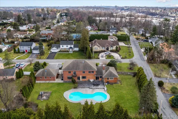 an aerial view of residential houses with outdoor space and lake view