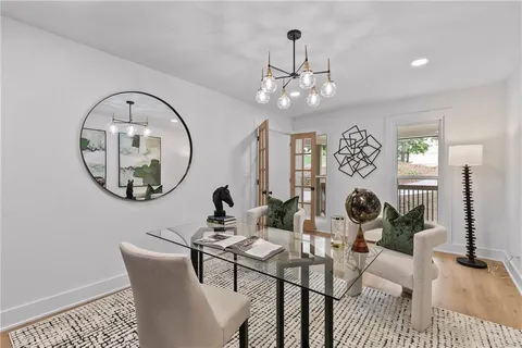 a view of a dining room with furniture a chandelier and wooden floor