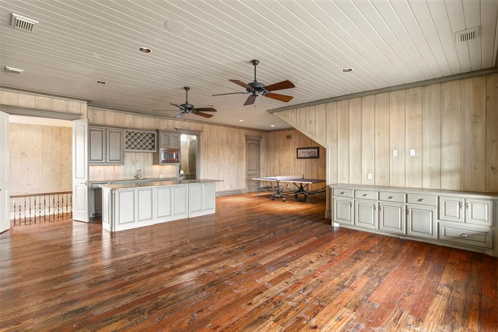 1096 Roadrunner Road Bartonville, TX 76226 - Photo 25 of 40 Upstairs gameroom with bar area and huge walk out attic space off this area. Also includes a hal bath and access to the second story balcony overlooking the pool.