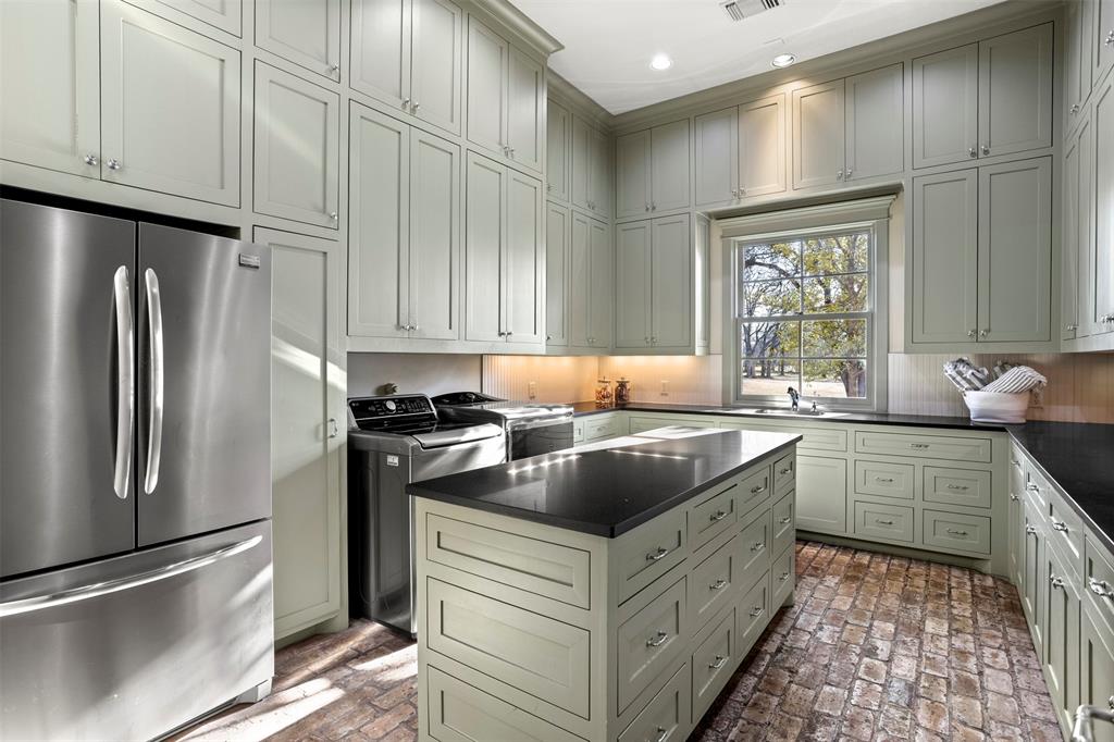 1096 Roadrunner Road Bartonville, TX 76226 - Photo 29 of 40 Oversized laundry room located on the first floor with large mudroom just outside that includes floor to ceiling built-in cabinets.