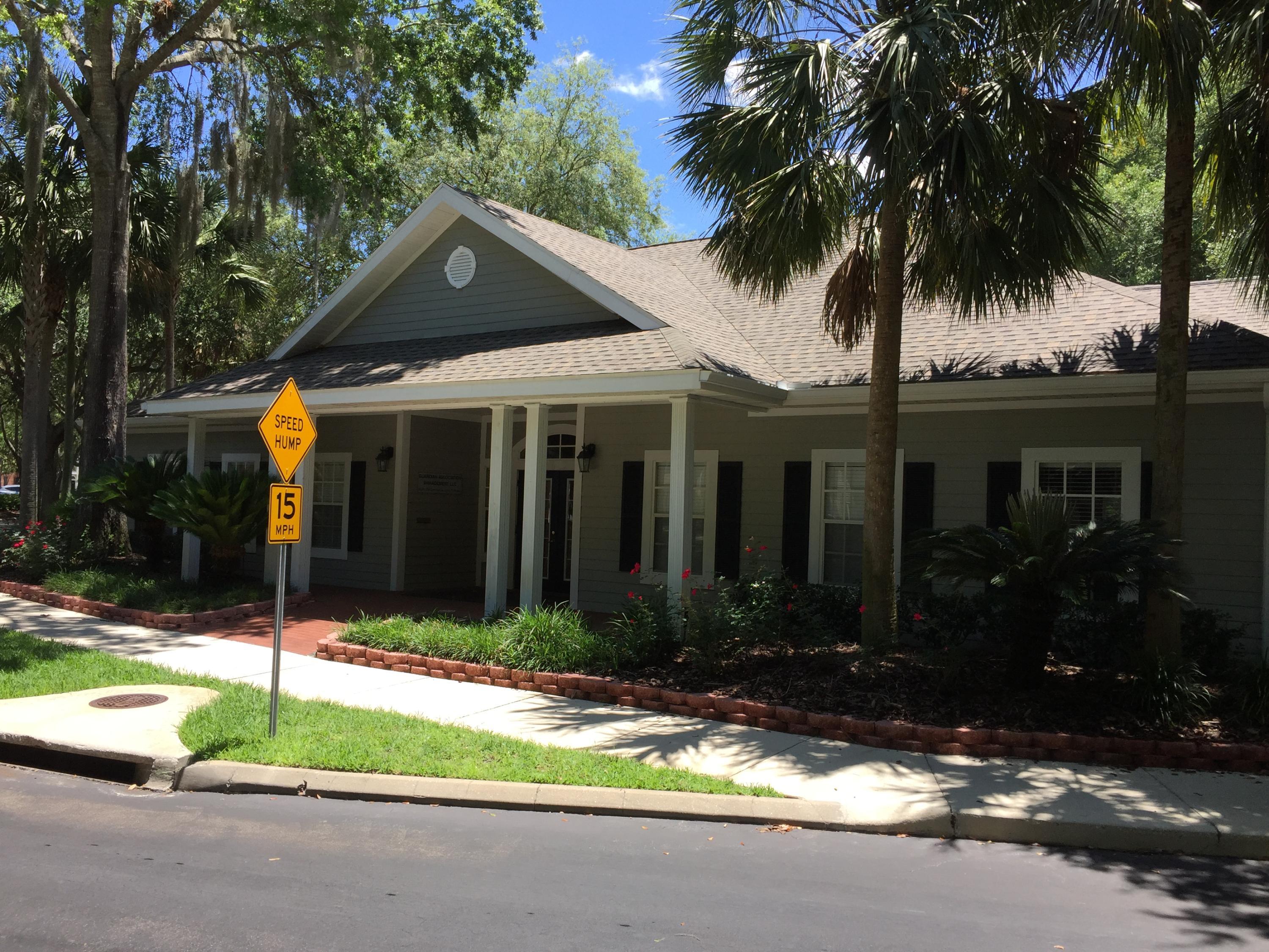 10000 Southwest 52nd Avenue, Unit 76 Gainesville, FL 32608 - Photo 21 of 21 front view of house with a yard and palm trees
