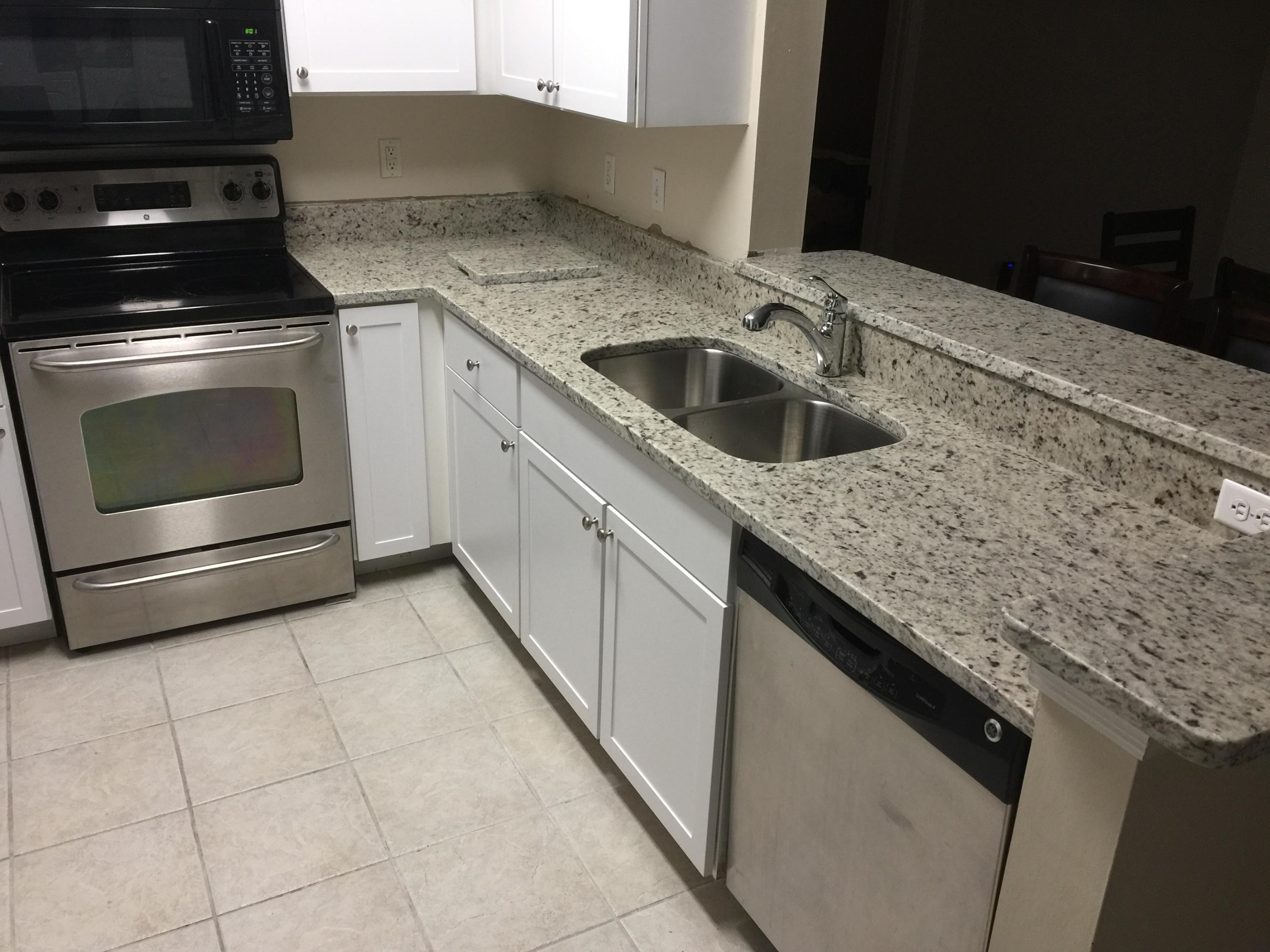 10000 Southwest 52nd Avenue, Unit 76 Gainesville, FL 32608 - Photo 3 of 21 a kitchen with granite countertop a sink and a stove