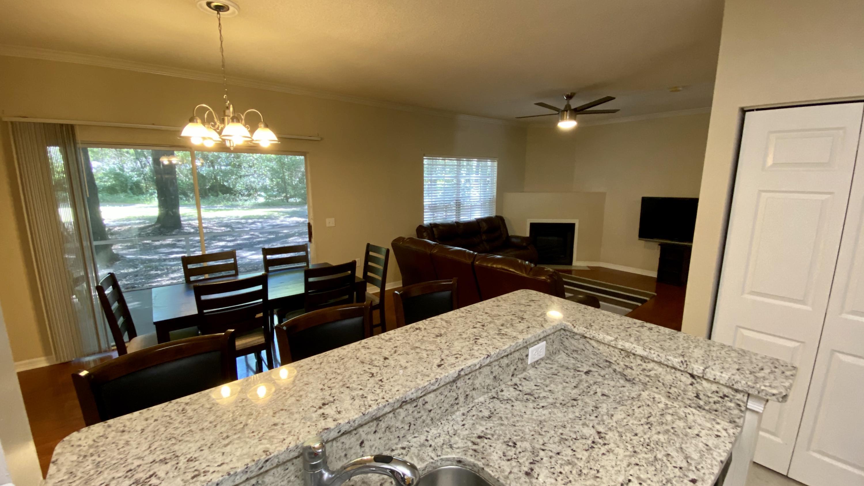 10000 Southwest 52nd Avenue, Unit 76 Gainesville, FL 32608 - Photo 6 of 21 a living room with furniture a flat screen tv and a fireplace