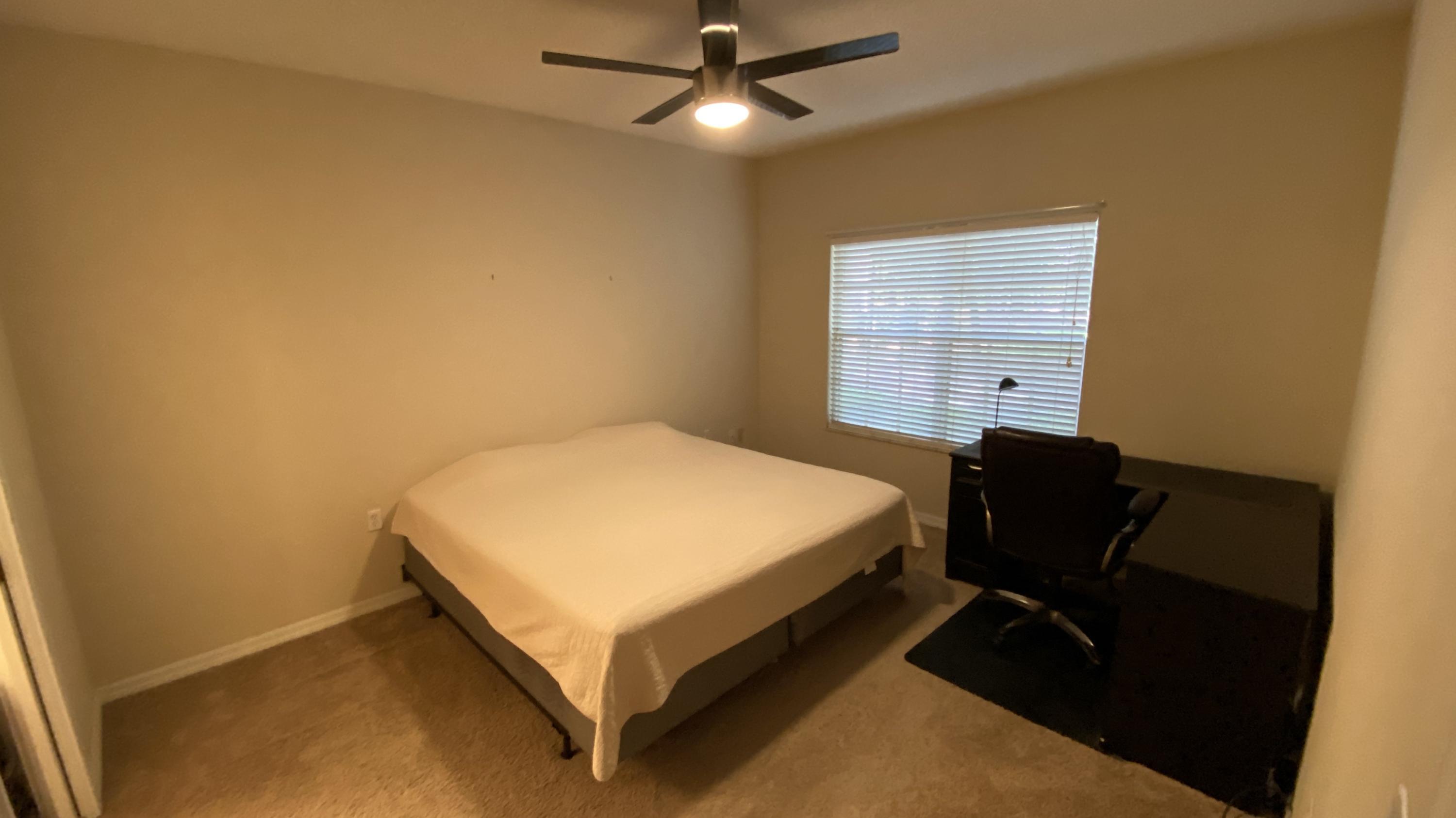 10000 Southwest 52nd Avenue, Unit 76 Gainesville, FL 32608 - Photo 7 of 21 a bed room with a bed and a chair