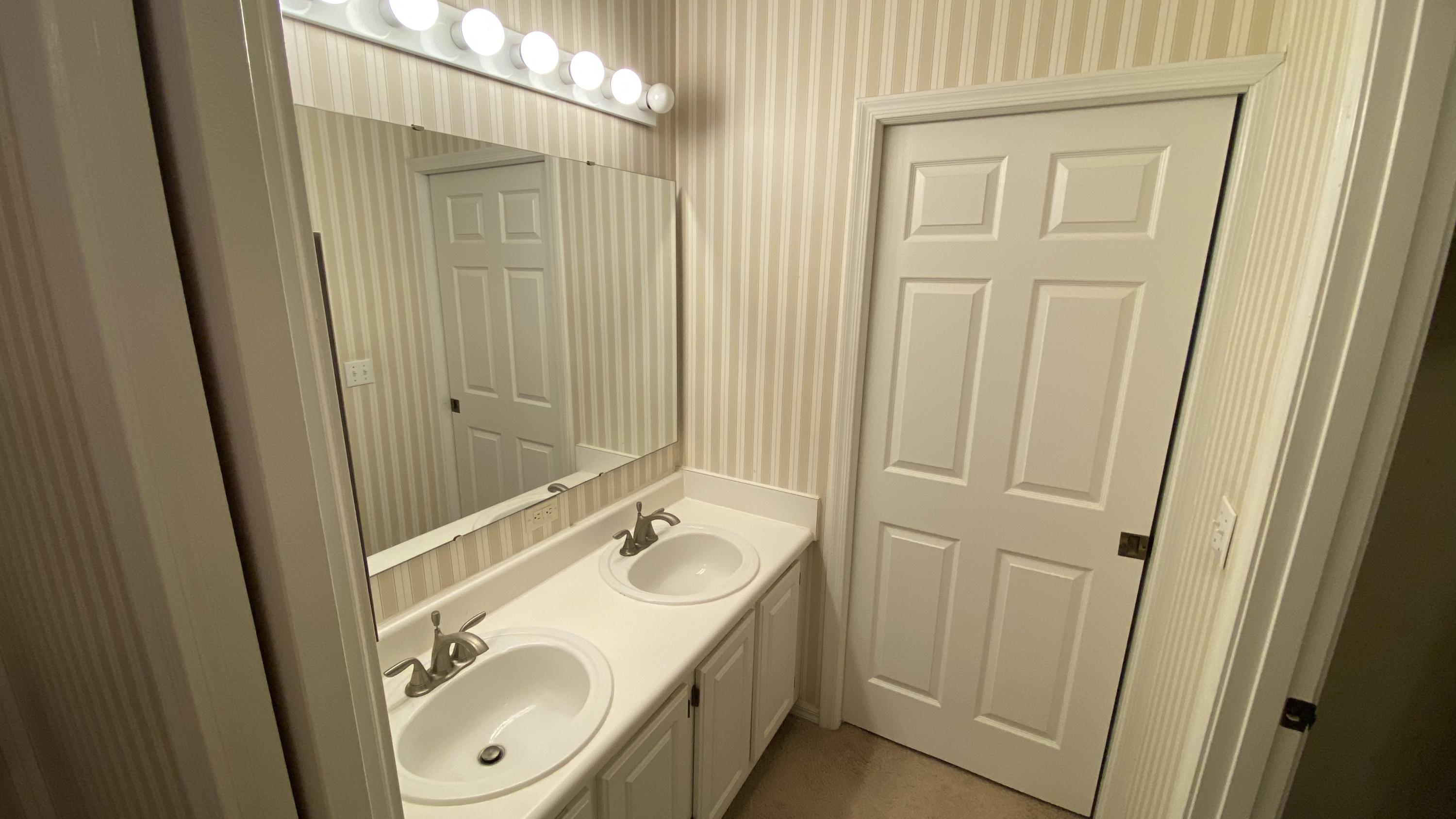 10000 Southwest 52nd Avenue, Unit 76 Gainesville, FL 32608 - Photo 8 of 21 a bathroom with a sink a toilet and a mirror