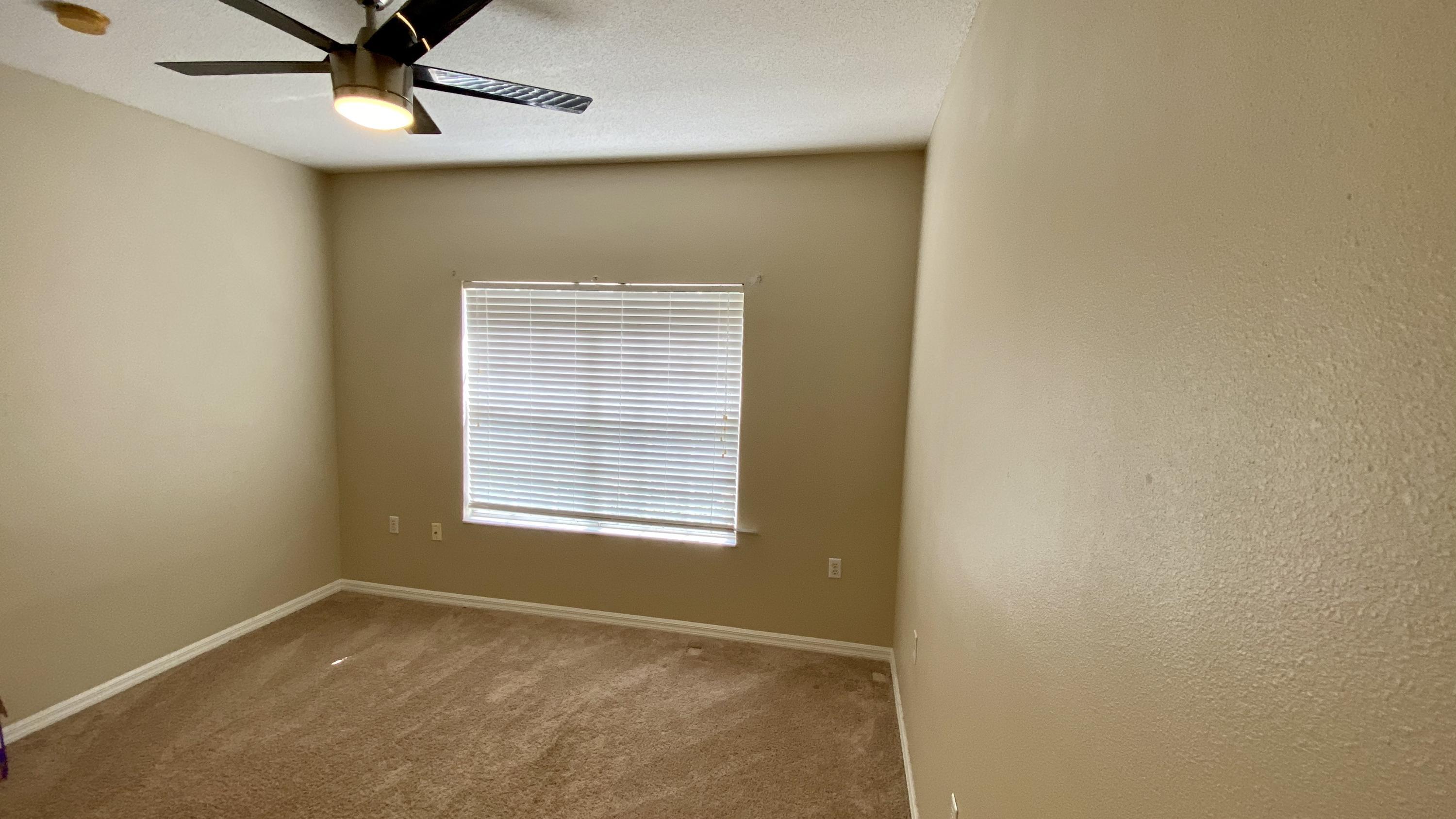10000 Southwest 52nd Avenue, Unit 76 Gainesville, FL 32608 - Photo 10 of 21 an empty room with a window and a ceiling fan