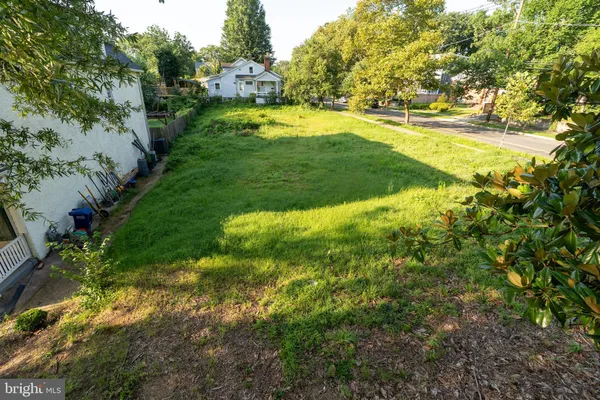 a view of yard with swimming pool and green space
