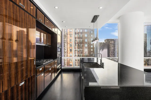 a kitchen with a table chairs refrigerator and cabinets