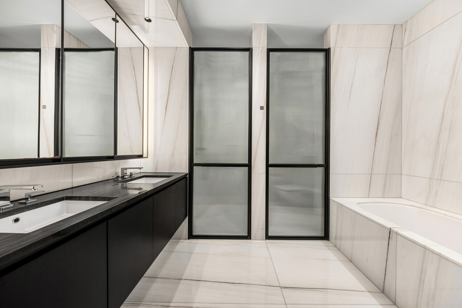 157 West 57th Street, Unit 43B Manhattan, NY 10019 - Photo 9 of 10 a bathroom with a bathtub and a sink