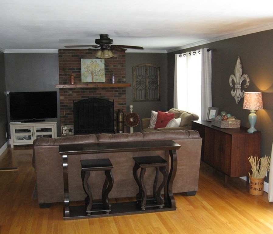 95 Grandview Street Springfield, MA 01118 - Photo 4 of 30 a living room with furniture a flat screen tv and kitchen view