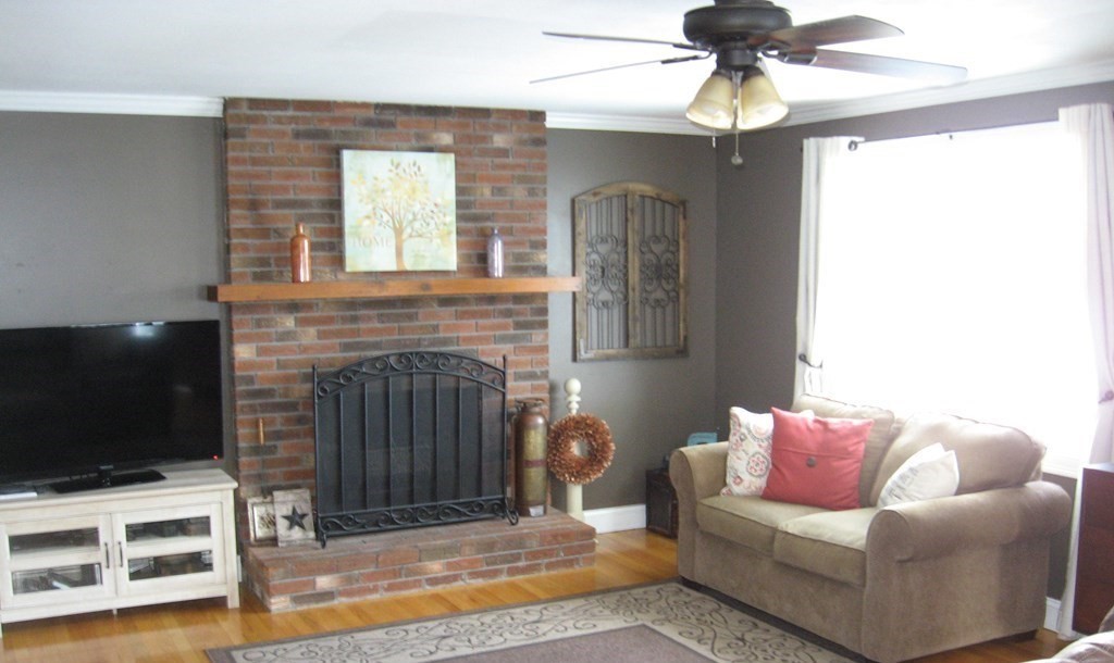95 Grandview Street Springfield, MA 01118 - Photo 5 of 30 a living room with furniture a flat screen tv and a fireplace
