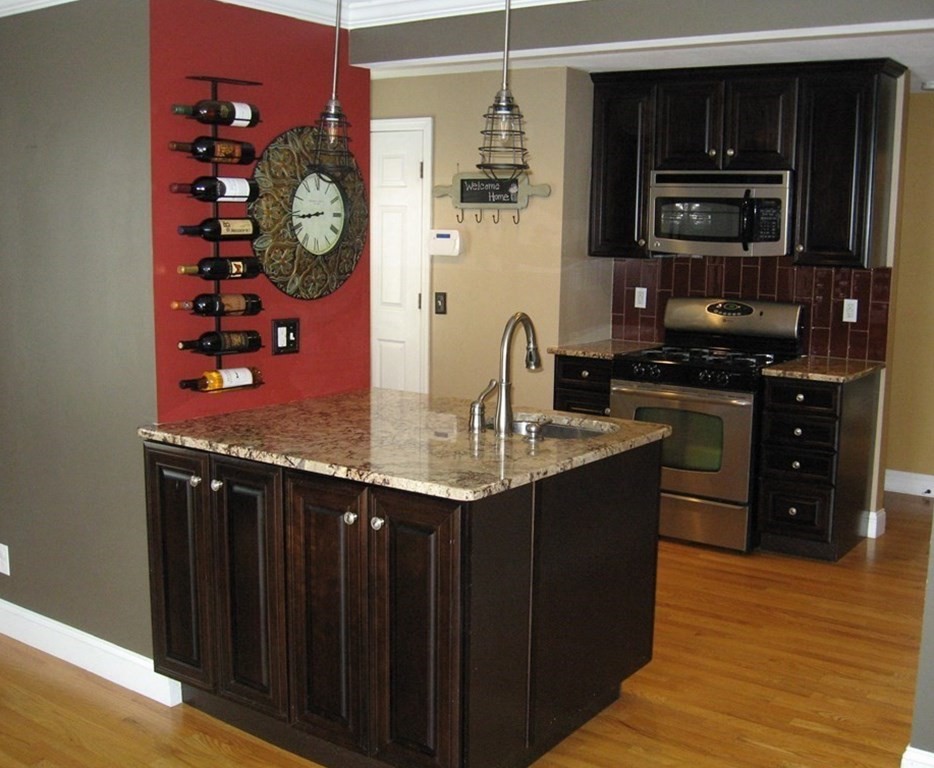 95 Grandview Street Springfield, MA 01118 - Photo 8 of 30 a kitchen with stainless steel appliances granite countertop a sink and a stove