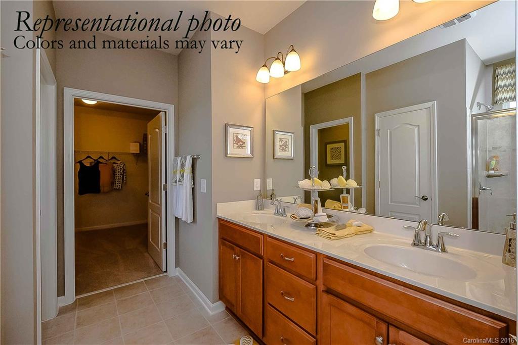 79175 Ridgehaven Road, Unit 151 Lancaster, SC 29720 - Photo 16 of 20 a bathroom with a granite countertop sink mirror and a shower
