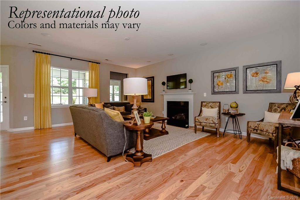 79175 Ridgehaven Road, Unit 151 Lancaster, SC 29720 - Photo 6 of 20 a living room with furniture a fireplace and a wooden floor