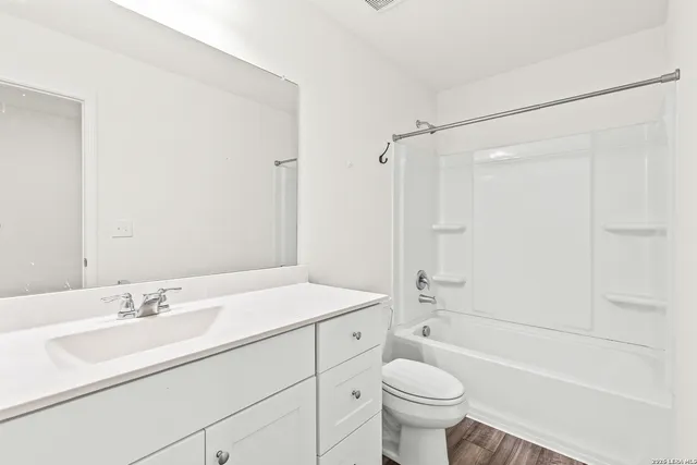 a bathroom with a sink a toilet and a large mirror