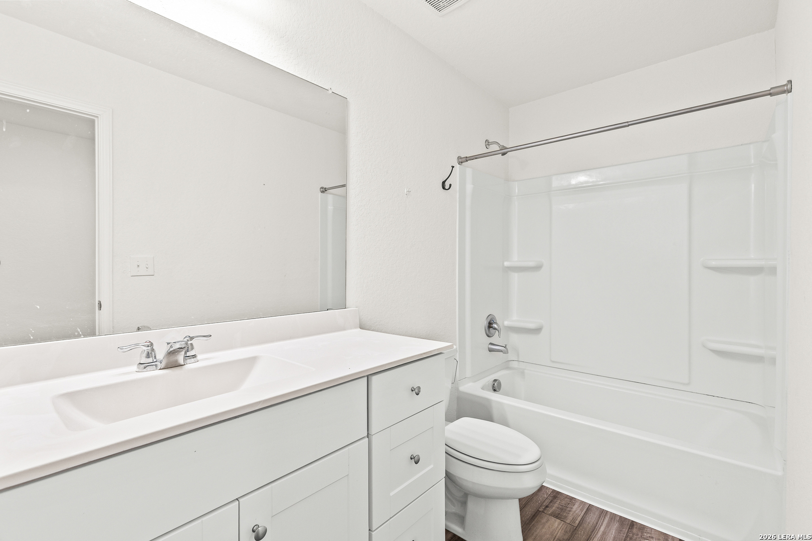 5802 Rue Picasso Converse, TX 78109 - Photo 18 of 23 a bathroom with a sink a toilet and a large mirror