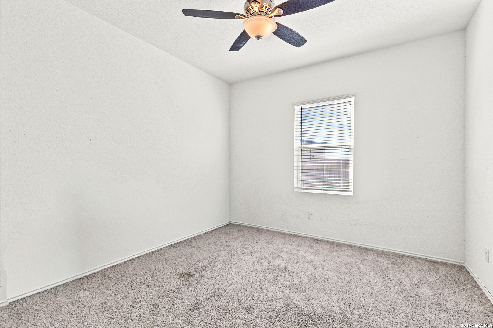 5802 Rue Picasso Converse, TX 78109 - Photo 8 of 23 an empty room with a window and a fan