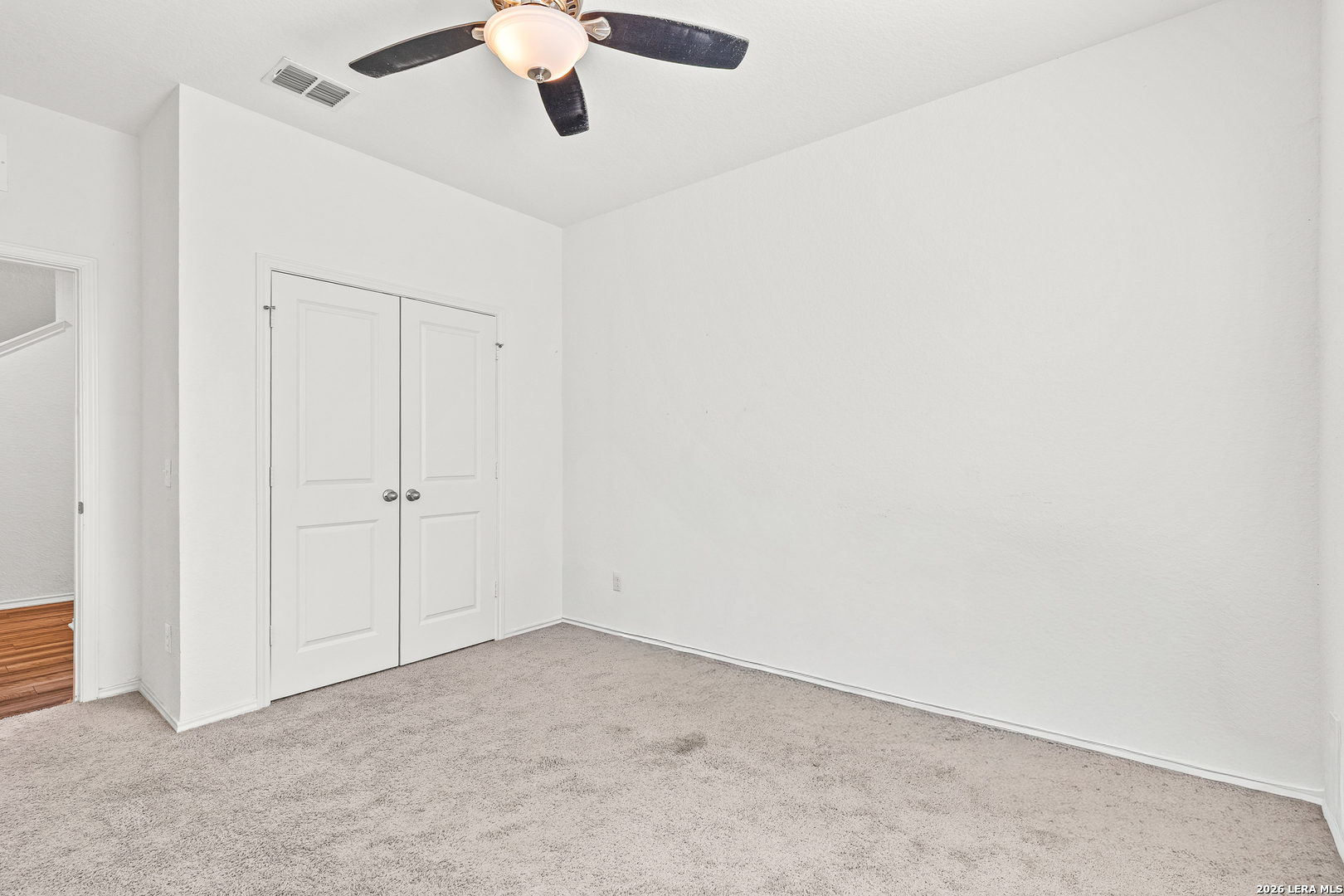 5802 Rue Picasso Converse, TX 78109 - Photo 9 of 23 an empty room with a ceiling fan and carpet