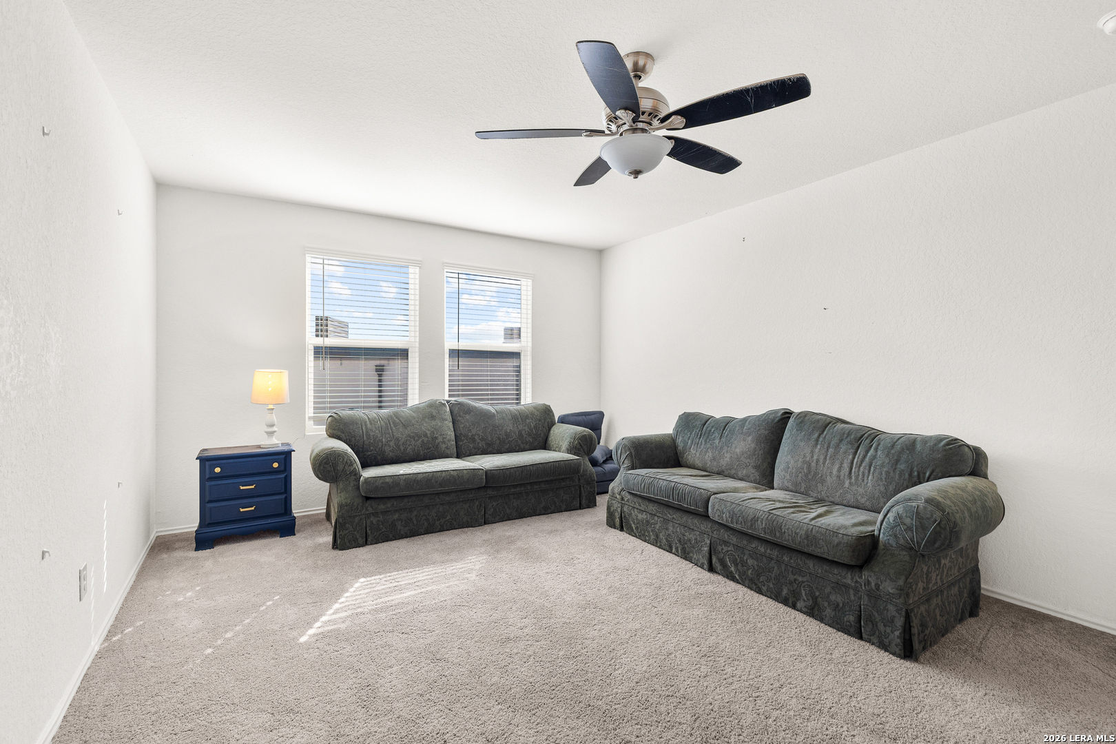 5802 Rue Picasso Converse, TX 78109 - Photo 10 of 23 a living room with furniture a window and a ceiling fan