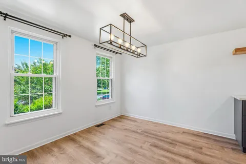 a view of a livingroom with wooden floor and a window