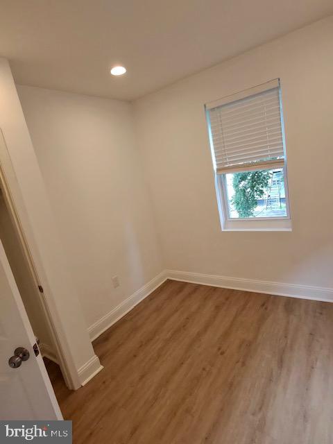 317 Decatur Street Northwest, Unit 4 Washington, DC 20011 - Photo 12 of 19 an empty room with wooden floor and windows