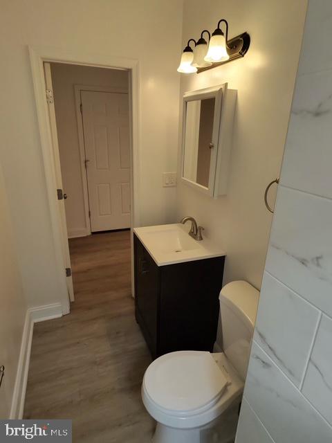 317 Decatur Street Northwest, Unit 4 Washington, DC 20011 - Photo 13 of 19 a bathroom with a toilet sink and mirror