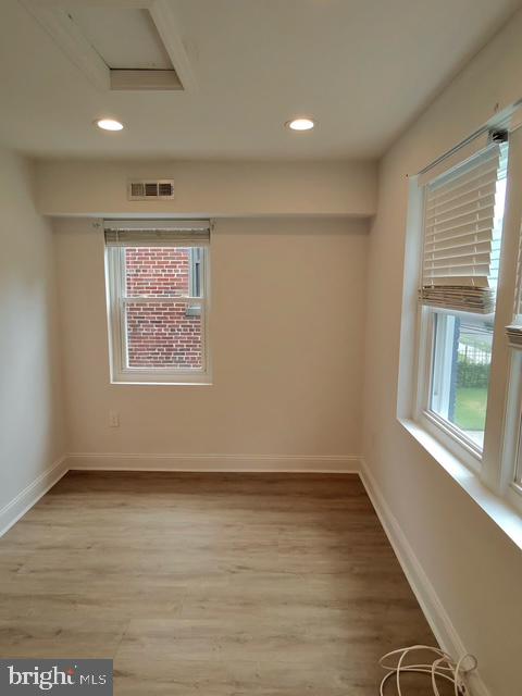 317 Decatur Street Northwest, Unit 4 Washington, DC 20011 - Photo 16 of 19 an empty room with wooden floor and windows