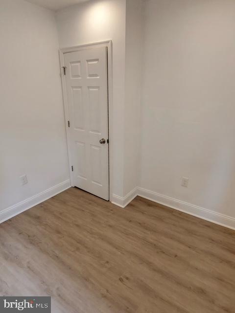 317 Decatur Street Northwest, Unit 4 Washington, DC 20011 - Photo 17 of 19 a view of an empty room with wooden floor