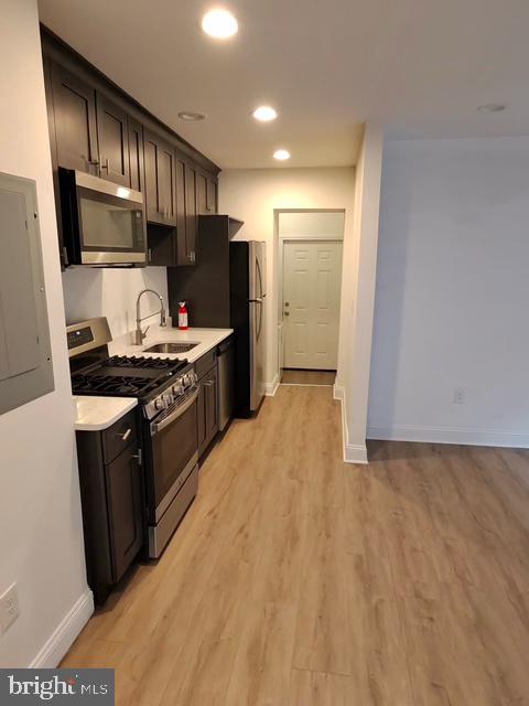 317 Decatur Street Northwest, Unit 4 Washington, DC 20011 - Photo 3 of 19 a kitchen with stainless steel appliances a refrigerator stove and sink