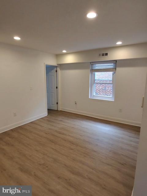 317 Decatur Street Northwest, Unit 4 Washington, DC 20011 - Photo 6 of 19 an empty room with wooden floor and windows