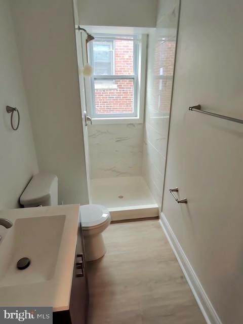 317 Decatur Street Northwest, Unit 4 Washington, DC 20011 - Photo 9 of 19 a bathroom with a sink a toilet and shower