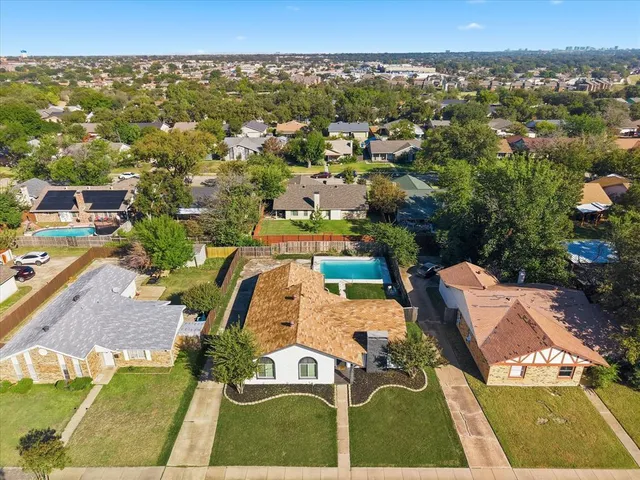 an aerial view of a house with a swimming pool