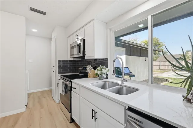 a kitchen that has a sink and a stove