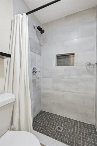 a bathroom with a shower and a toilet