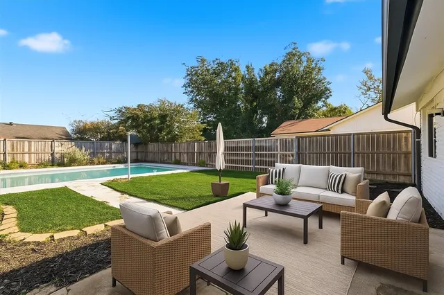 a view of a patio with couches and a big yard