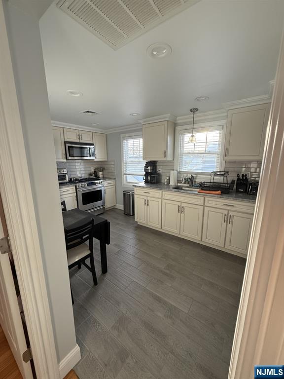 337 2nd Street Saddle Brook, NJ 07663 - Photo 3 of 9 a kitchen with a sink a stove a refrigerator cabinets and a window