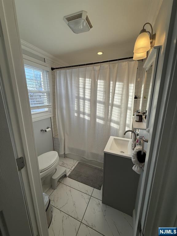 337 2nd Street Saddle Brook, NJ 07663 - Photo 7 of 9 a bathroom with a sink a toilet and a mirror