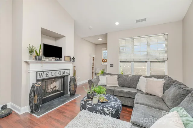 a living room with furniture a fireplace and a flat screen tv