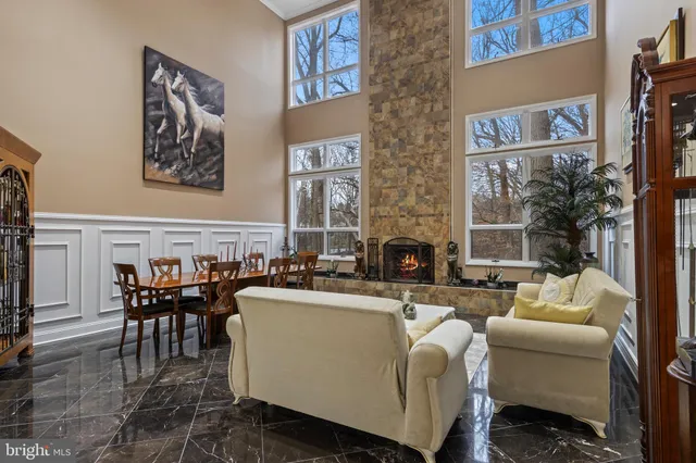 a living room with furniture and a book shelf