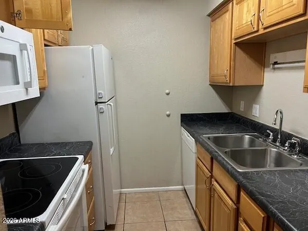 a kitchen with a sink and a refrigerator