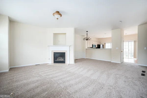 a view of an empty room with a fireplace